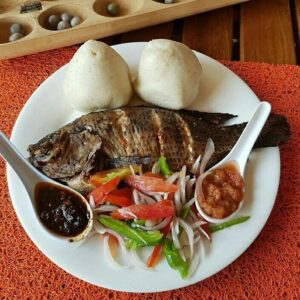 Whole Grilled Tilapia, served with original Ghana banku, red pepper sauce, The Doctor’s Menu Chilli Sauce(shi-tor) and vegetables