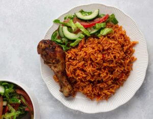 48oz bowl of Ghana Jollof, chicken and Salad