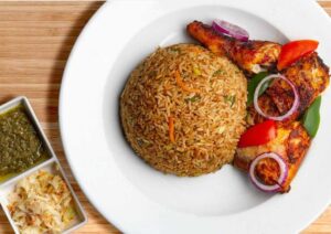 48oz bowl of Ghana Fried Rice, chicken and Salad